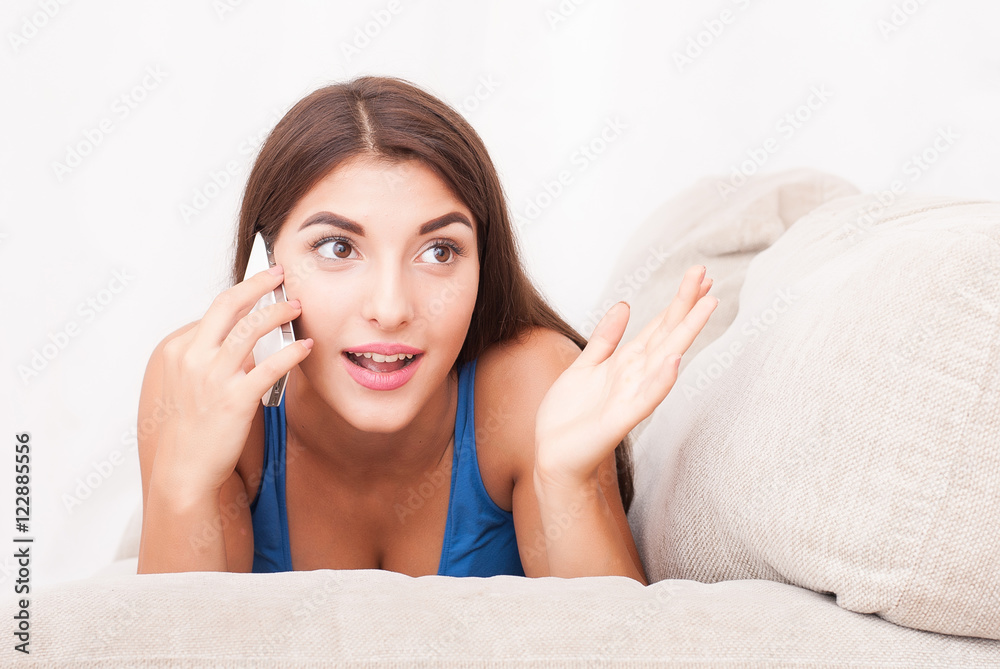 girl using her smartphone on the couch at home girl using her smartphone on the couch at home
