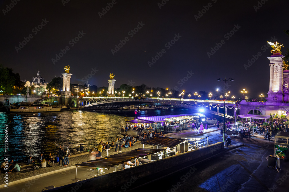 Street on the waterfront of Paris by night in summer