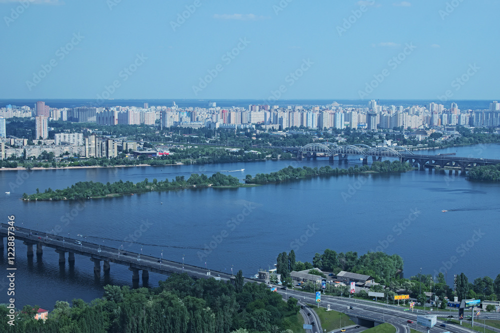 Kiev, Ukraine - 25 May 2015: Aerial view of the city buildings, Dnieper River and bridges from Monumental statue Mother Motherland