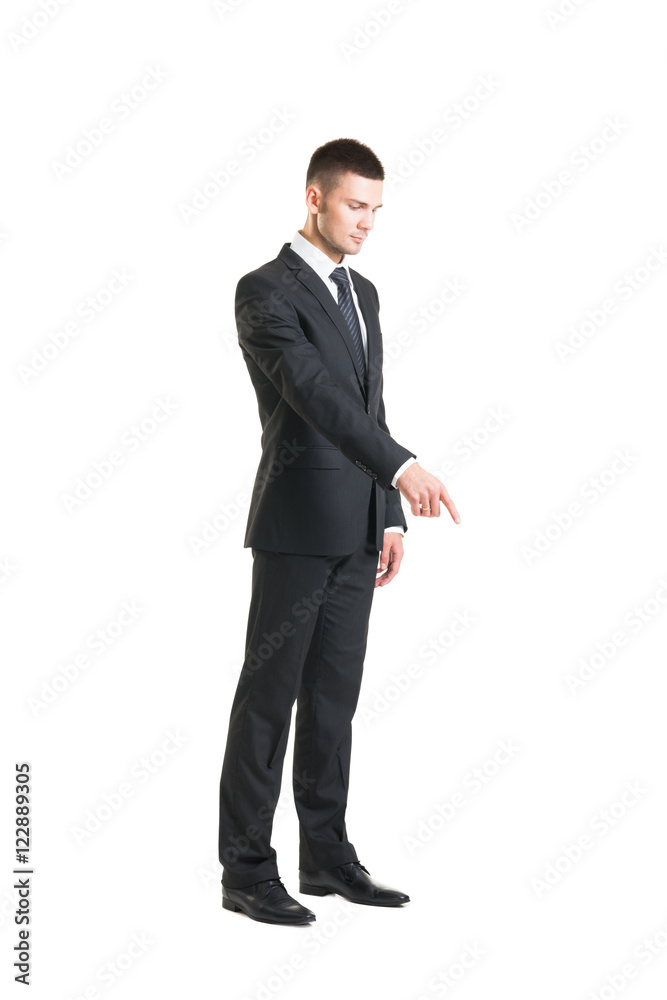Young businessman pointing at something on white Young businessman pointing at something on white