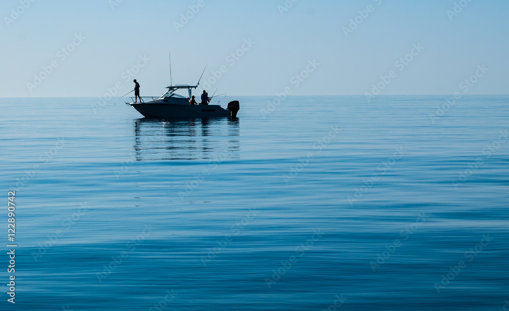 Silhouette of Sport Fishing boat in calm water