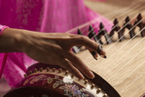 Woman play a traditional korean twelve string instrument : the gayageum