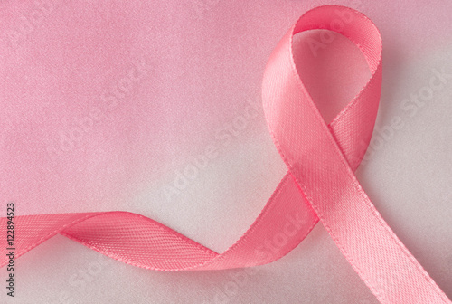 Pink ribbon. National Breast Cancer Awareness Month. Mammography Day. Silk background textured yarns.