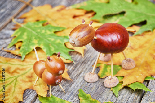 Small creatures made of chestnuts and acorns. Autumnal decoratio