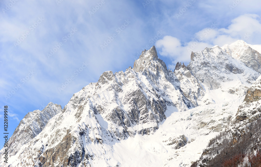 snow covered alps on a sunny winter day with blue sky and white clouds on the Italian side of the Mont Blanc tunnel snow covered alps on a sunny winter day with blue sky and white clouds on the Italian side of the Mont Blanc tunnel