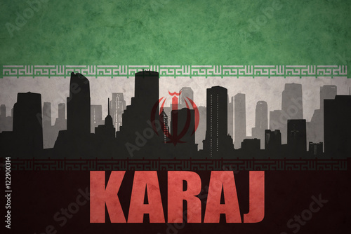 abstract silhouette of the city with text Karaj at the vintage iranian flag background photo