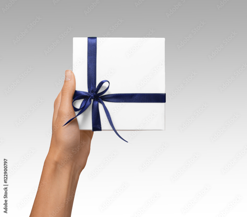 Isolated Woman Hands holding Holiday Present White Box with Blue Ribbon on a White Background