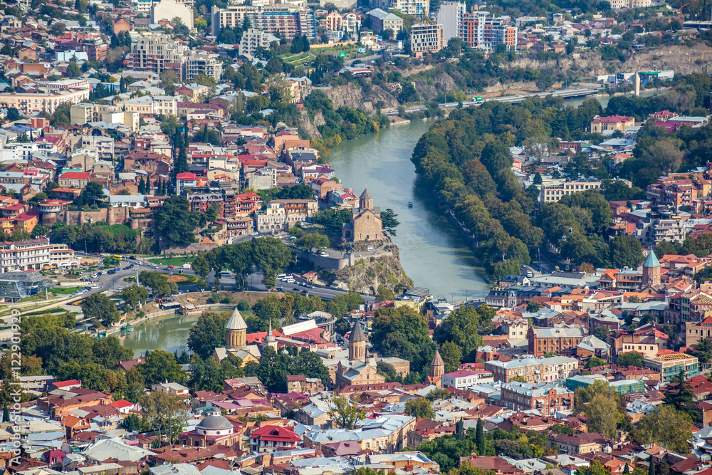 Aerial view of Tbilisi city with Kura river and Metekhi church o