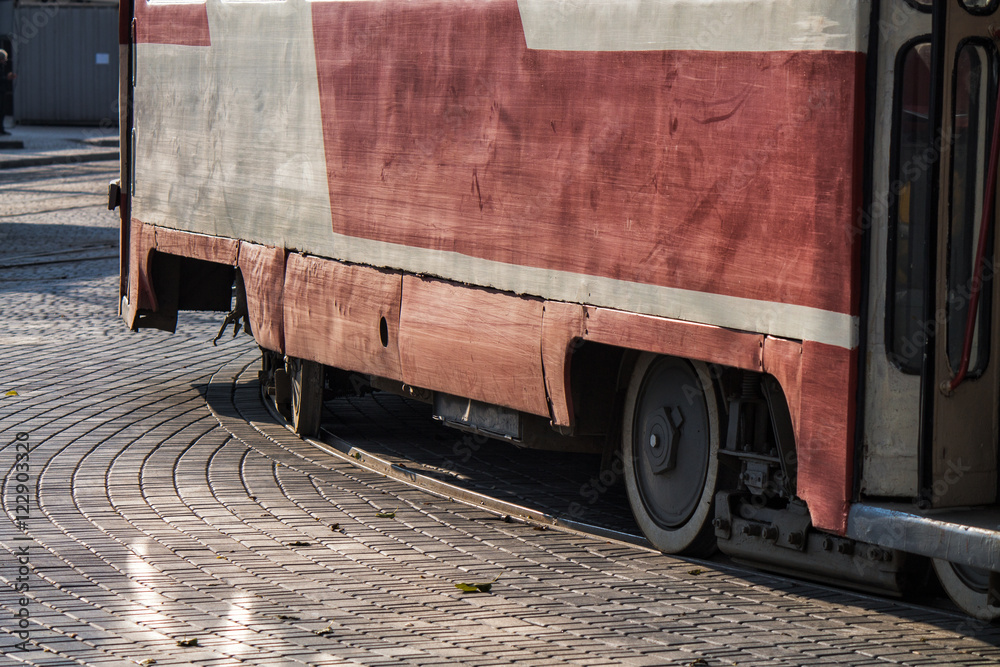 Naklejka premium Old soviet union tram rides on rails in the city