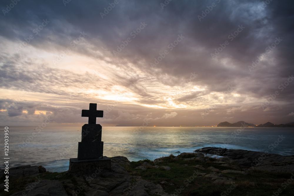 Stone cross monuments by the sea in the sunrise, Castro Urdiales, Cantabria
