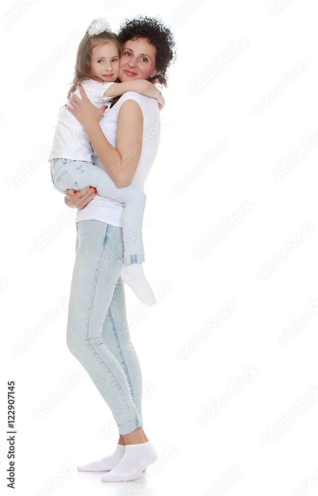 Mom and daughter in jeans white shirts Mom and daughter in jeans white shirts