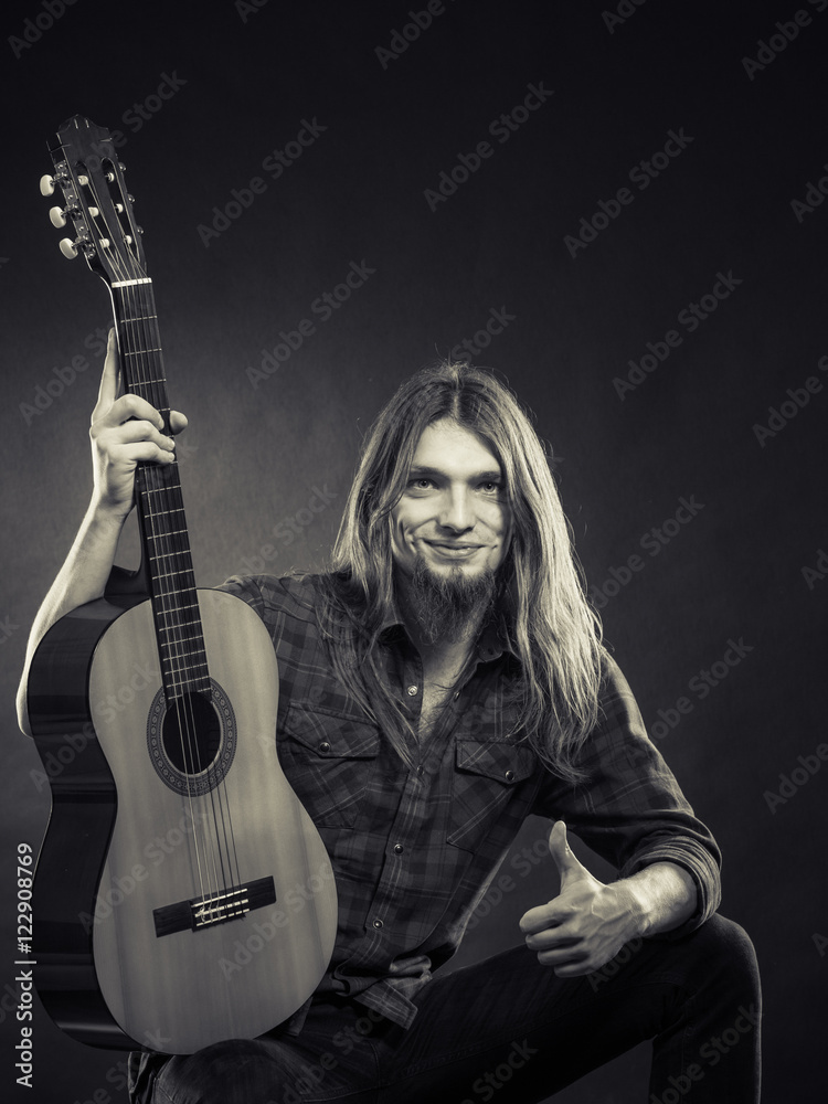 Young man holding guitar.