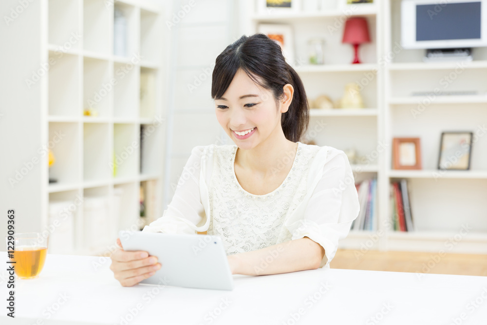 portrait of young asian woman using tablet computer