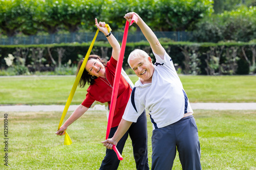 Senior Couple Exercising With Yoga Belt