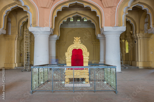 Madurai, India - October 21, 2013: Copy of the golden throne of the Nayak at main audience hall of his palace. Fence shields throne from public. photo