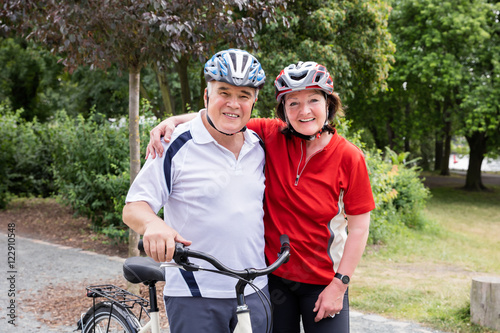 Portrait Of Smiling Couple With Bicycle