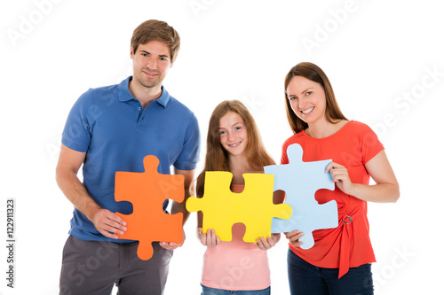 Family Holding Jigsaw Puzzle Pieces