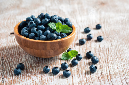 Blueberries in bowls, rustic style, wooden background, selective focus