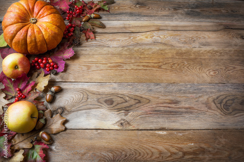 Thanksgiving or fall greeting with pumpkins, berries and fall le
