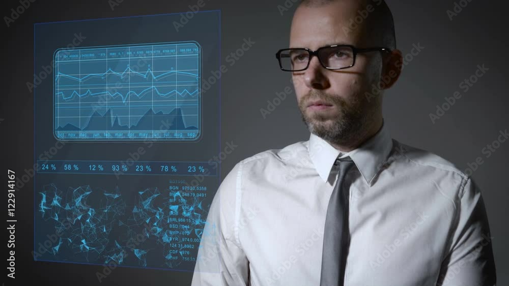Future work with finance and macro economy. Businessman working with an interactive holographic screen. Future work with finance and macro economy. Businessman working with an interactive holographic screen.