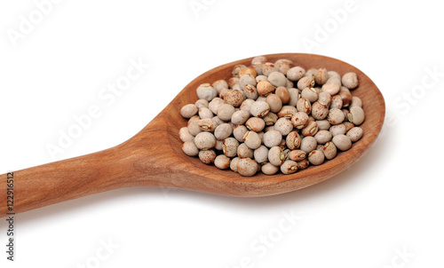 a pile of pigeon pea on wooden spoon on white background