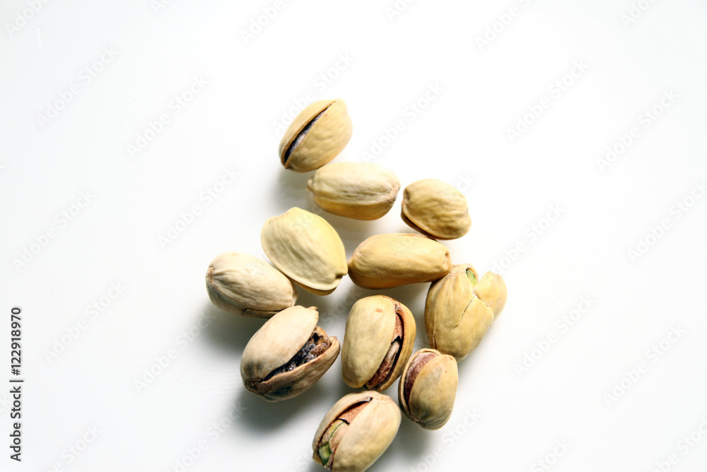  Pistachio in white background / Wonderfully delicious pistachio nuts have long been revered as the symbol of wellness and robust health since ancient times