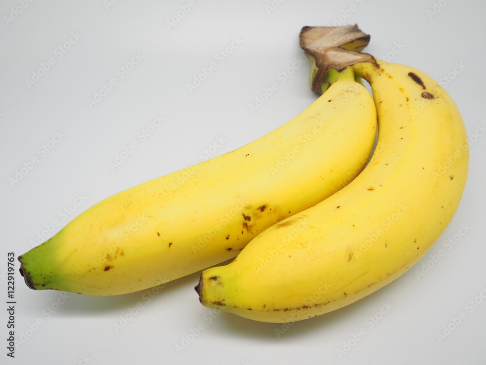 Fully riped yellow thai banana on white screen with exclamation mark on skin