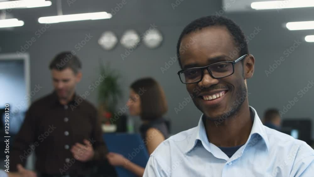 Handsome young smiling businessman posing on camera. Handsome young smiling businessman posing on camera.