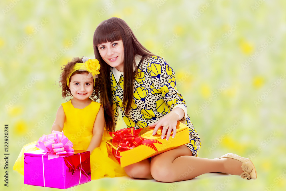 Mom and daughter with gifts in the New year Mom and daughter with gifts in the New year