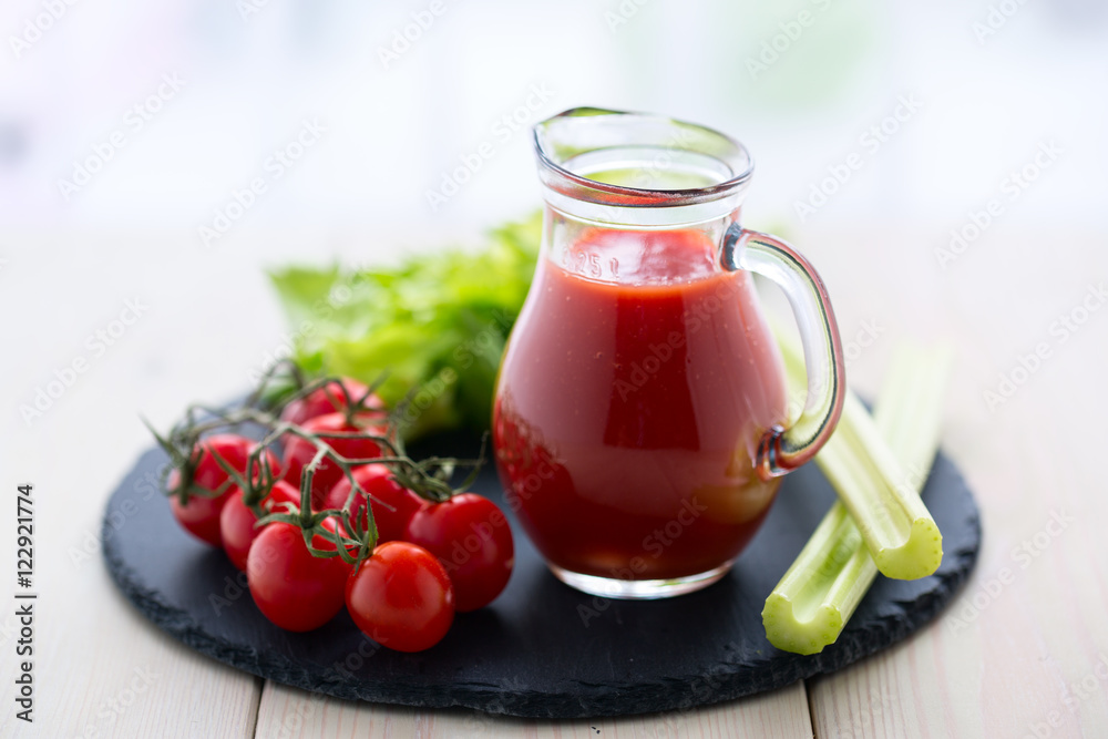 Tomato juice in a glass jar on wooden table. Tomato juice in a glass jar on wooden table.