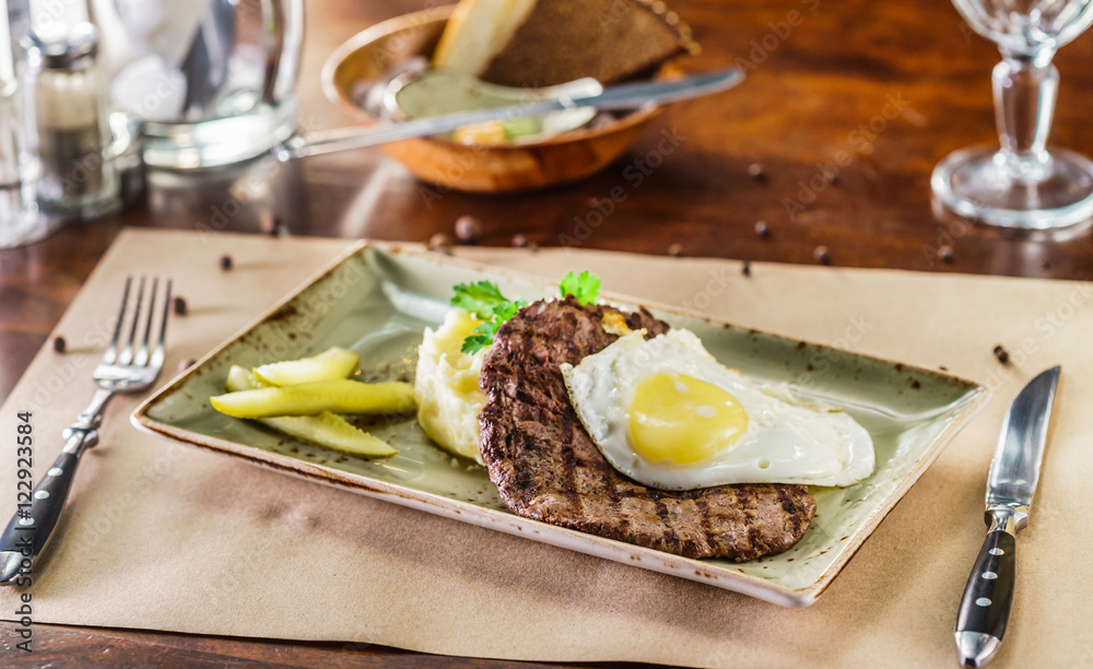 steak with egg and mashed potato