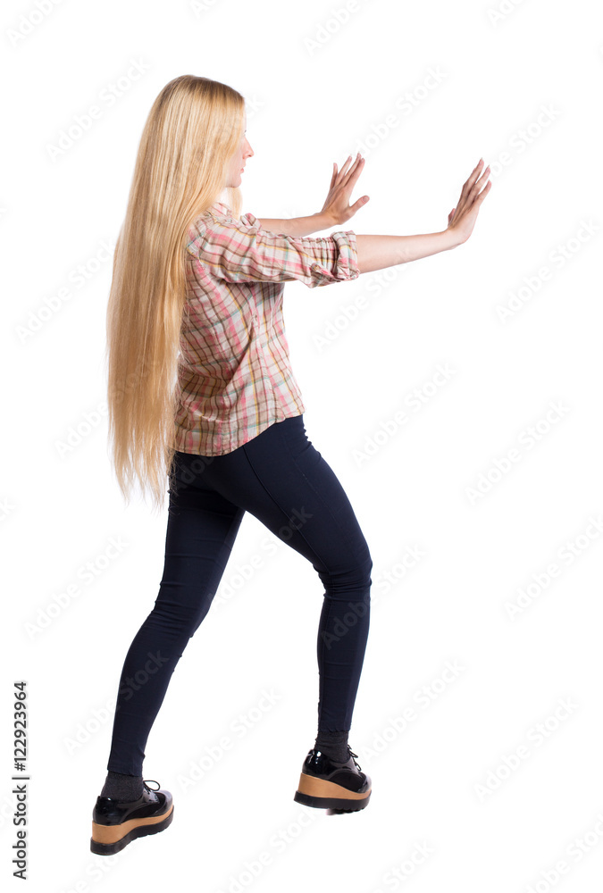 back view of woman pushes wall. Isolated over white background. Rear view people collection. backside view of person. Girl with very long hair that shoves his hands in his side. back view of woman pushes wall. Isolated over white background. Rear view people collection. backside view of person. Girl with very long hair that shoves his hands in his side.