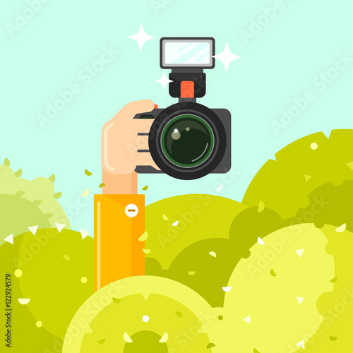 Photographer hand holds photo camera vector illustration. Spy hides in green bushes with photo camera. Journalists sit in ambush and make sensational shot. Photographer concept in flat style