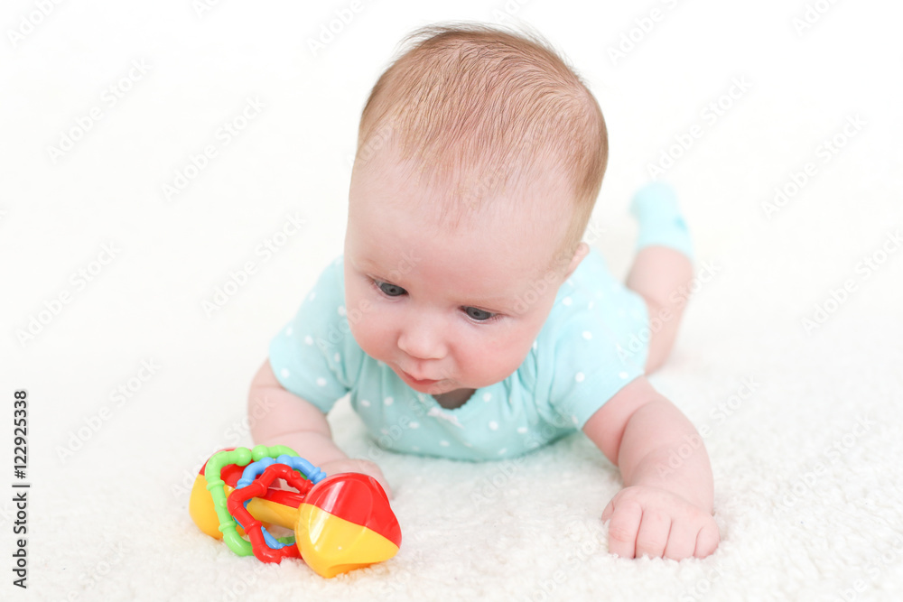 Lovely 2 months baby girl plays with rattle Lovely 2 months baby girl plays with rattle