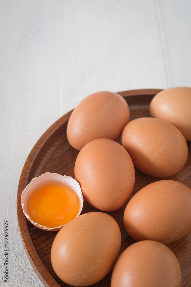Egg in a wooden bowl on wooden table white. Chicken Egg. Top view with copy space Egg in a wooden bowl on wooden table white. Chicken Egg. Top view with copy space