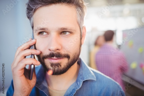Close-up of businessman listening to cellphone