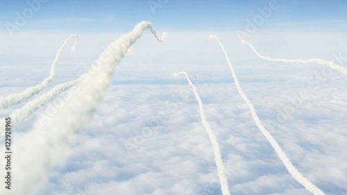 Swarm of rockets fired POV over the clouds winding into distance