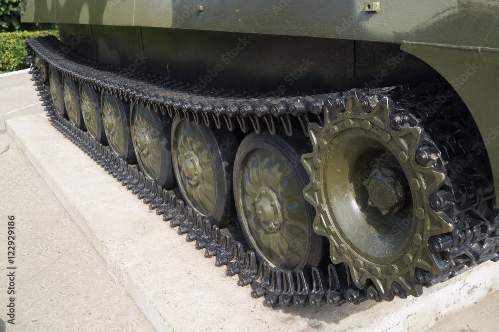 Tracks and wheels of military equipment. Exhibited on a plinth military equipment.