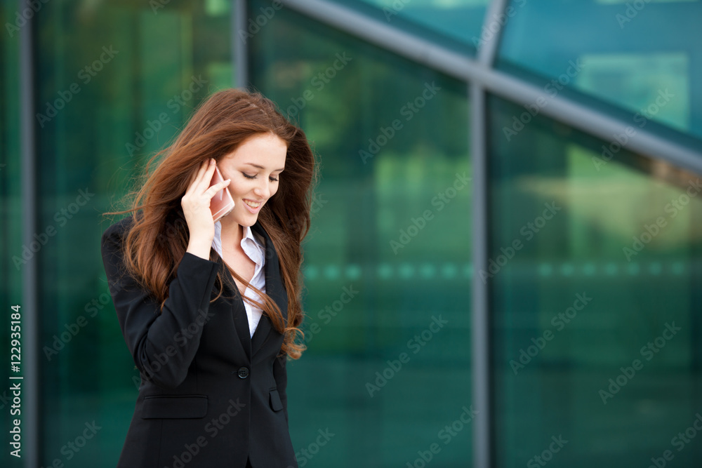 Business woman walks outdoor with smartphone talking to her team Business woman walks outdoor with smartphone talking to her team