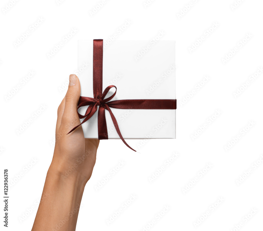 Isolated Woman Hands holding Holiday Present White Box with Brown Ribbon on a White Background