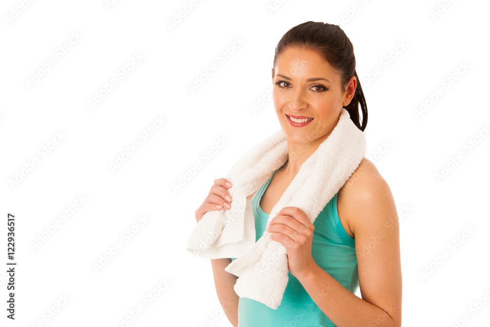 Woman rests after fitness workout with towel around her neck iso Woman rests after fitness workout with towel around her neck iso