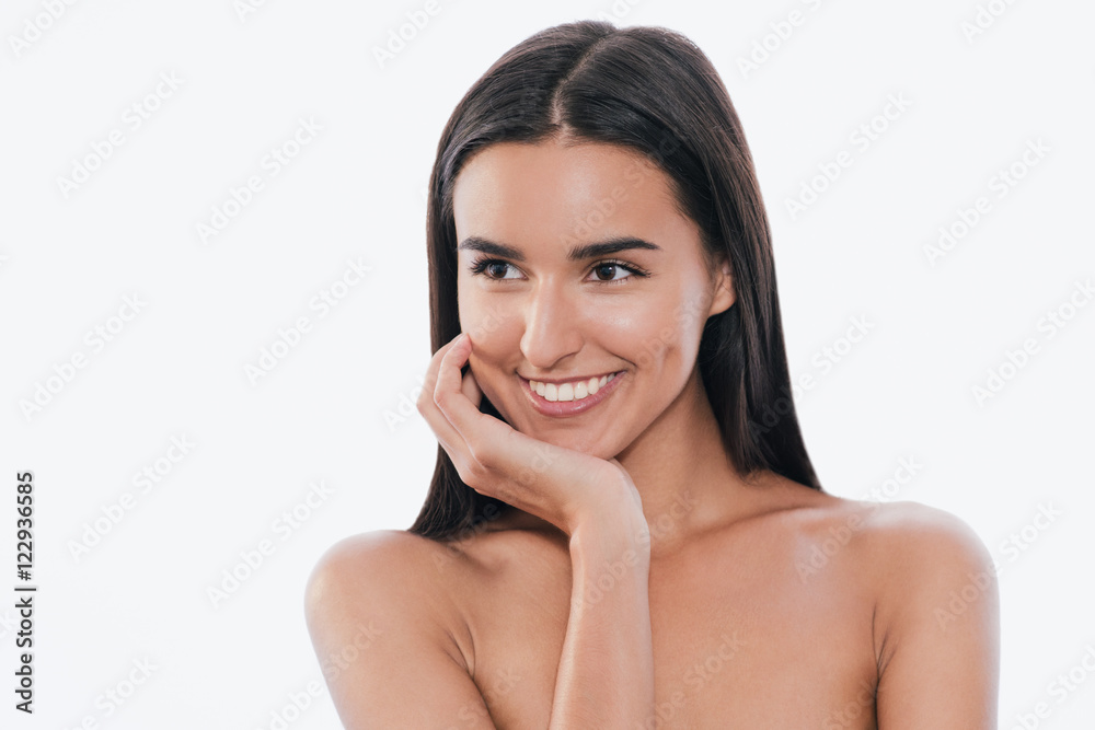 Portrait of cute young smling woman touches her clean skin, on white background. Portrait of cute young smling woman touches her clean skin, on white background.