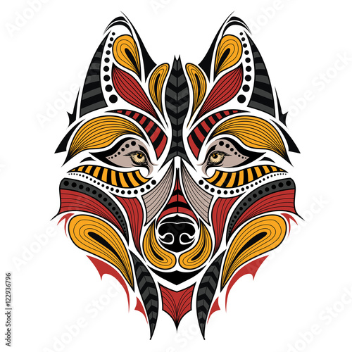 Patterned colored head of the wolf. African   indian   totem   tattoo design. It may be used for design of a t-shirt  bag  postcard and poster.