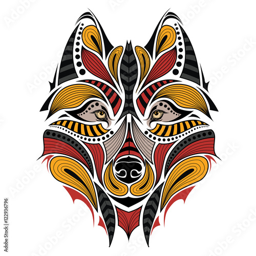 Patterned colored head of the wolf. African / indian / totem / tattoo design. It may be used for design of a t-shirt, bag, postcard and poster.