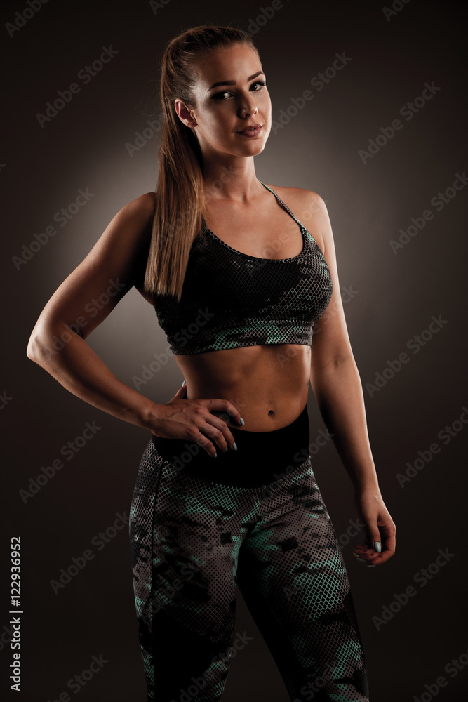 fit woman workout with dumbbells in gym studio photography of a fit woman workout with dumbbells in gym studio photography of a