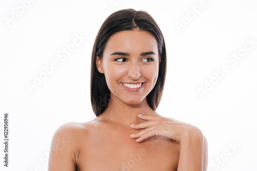 Young and beautiful woman touches her neck, on white background.