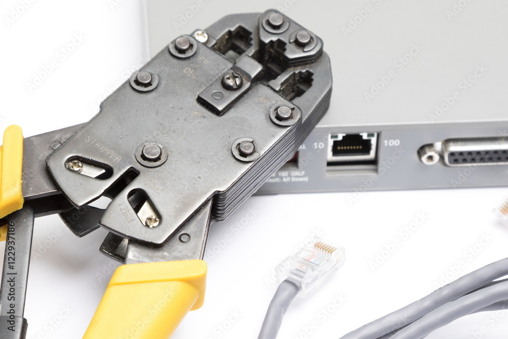 Crimping tool and network cable on white background Crimping tool and network cable on white background