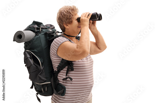 Senior hiker looking through binoculars
