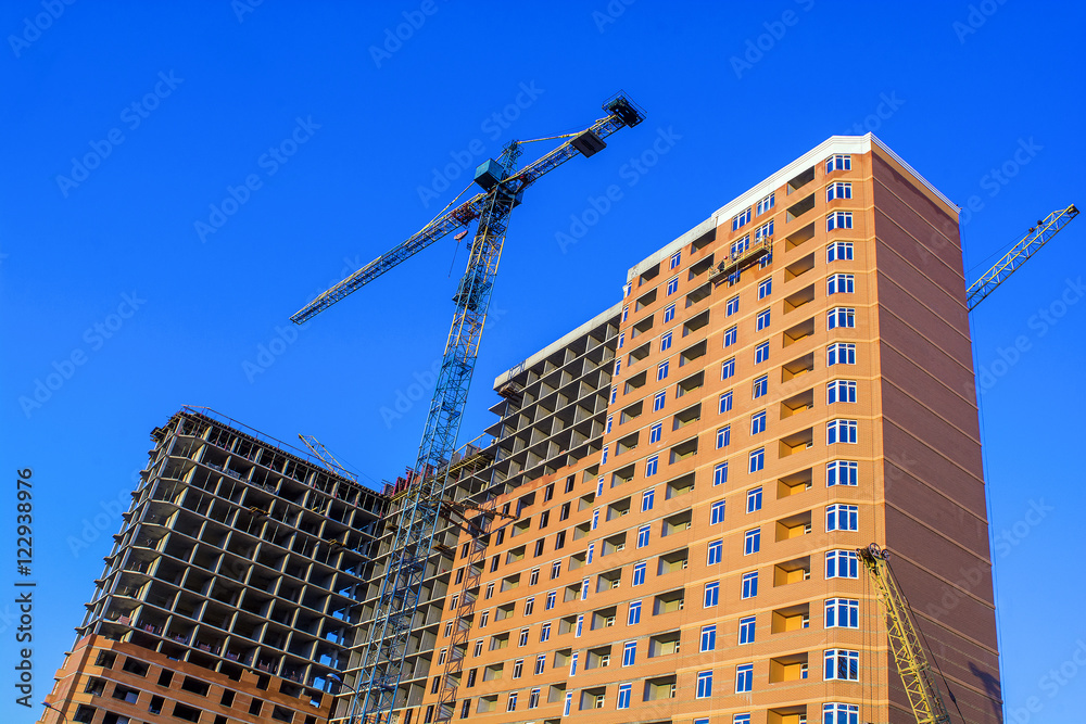 Fototapeta premium building of a multistory building. Crane. On the background of the sky