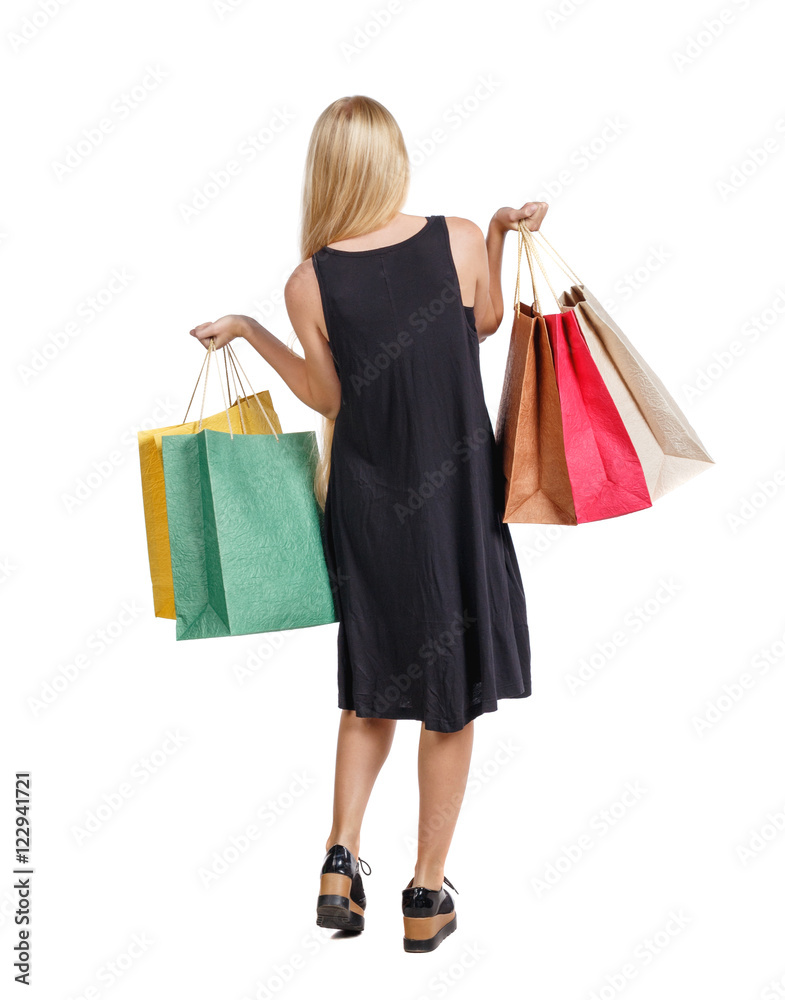 back view of woman with shopping bags . beautiful brunette girl in motion.  backside view of person.  Rear view people collection. Isolated over white background. Long-haired blond girl holding